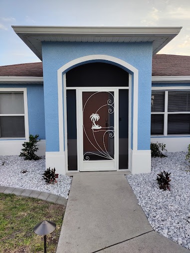 Decorative screen door installation Florida home